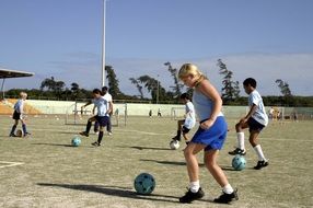 girls and boys on soccer training