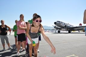 girls playing in airport at plane