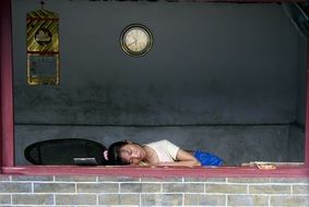 girl sleeping on the wall in china