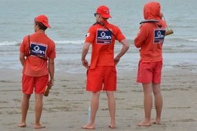 three lifeguards on the sandy beach