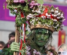 green man with flower on a hat