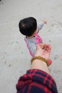 mom pulls a hand to the baby