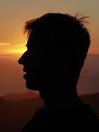 profile silhouette of human head on sunset