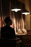 man sitting in dim light