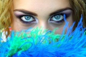 blue eyes of a woman with bright makeup