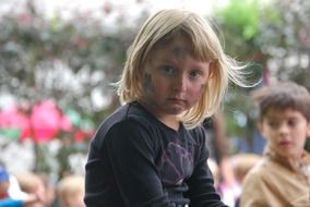 Portrait of the blonde girl and boy at blurred background