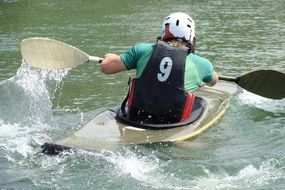 athlete with number nine canoeing on the river
