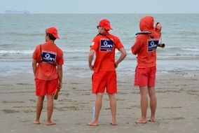 rescuers job people in uniform sea beach