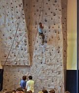 girl climbs the wall while climbing