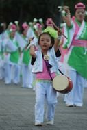 little asian girl playing drums