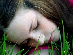girl sleeping on a green lawn