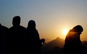 people pray at sunrise