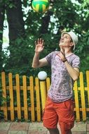 caucasian young man plays volleyball outdoor