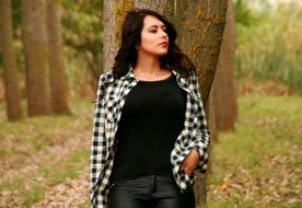 Beautiful brunette by the tree