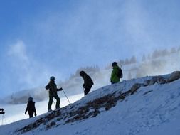 skiers on the snowy side of the mountain