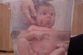 newborn baby taking bath