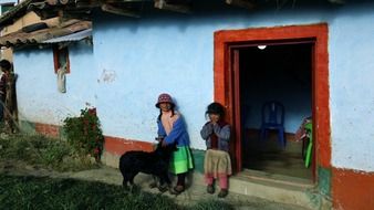 children at the door of the house in bolivia