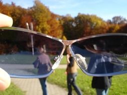 people in park, view through sunglasses