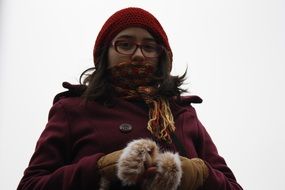 the girl in gloves was wrapped from the cold
