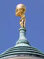 golden statue with a ball on the dome of the temple in Potsdam
