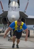 strong man pulls the plane