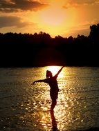 girl` silhouette sunset water