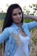 young beautiful brunette posing in the field