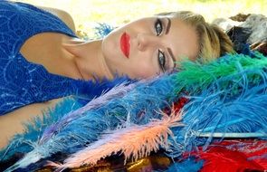 girl with blond hair on feathers