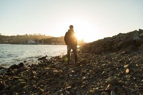 young man on the beach at sunset