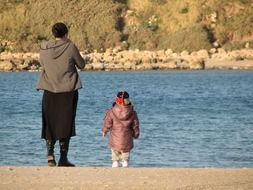 mother with baby near water