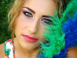 girl with beautiful make-up and decorative feathers