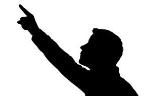 silhouette of a man pointing with a finger