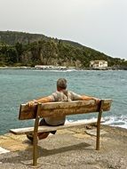 man on the bench, contemplate the beauty of water