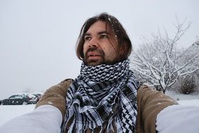 portrait of a bearded man in a snowy landscape