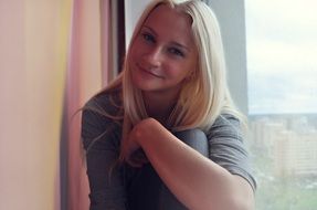 blonde girl portrait at the window