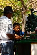 photo of a black boy and parent in the park