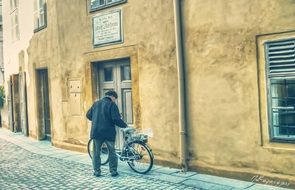 an elderly man with a Bicycle on the street vienna