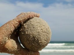 sand ball in the hand child keep beach