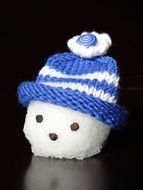 head of a snow man in blue cap