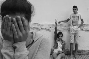 black and white photo of children playing hide and seek