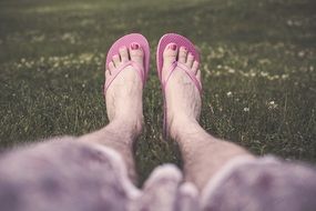 man in flip flops with pedicure