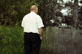 man looks into the distance on the field