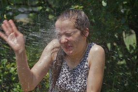 splatter of water in face of child girl