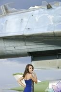 Girl in blue dress near the airplane