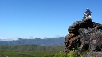 man on top of stone