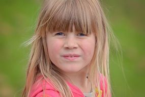 a girl is squinting