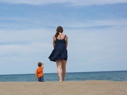 child and girl go on the beach