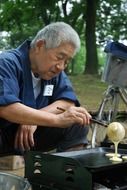 old man cooking traditional Japanese dessert Dorayaki