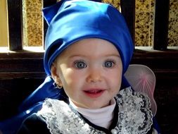 little girl in a blue kerchief
