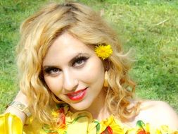 portrait of a blonde with a dandelion in her hair